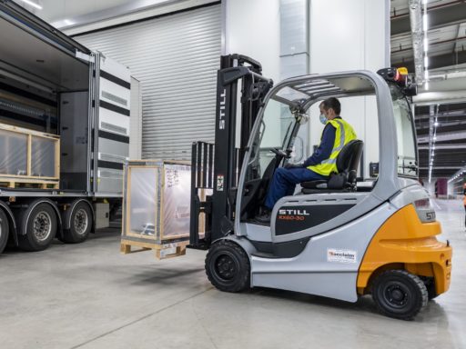 A forklift truck moves an object in the collection management facility.