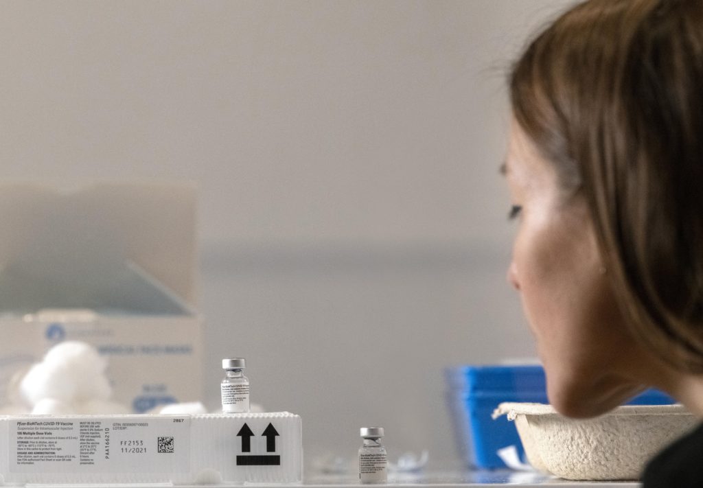 A visitor looks at a vial of COVID-19 vaccine in Injecting Hope: The race for a COVID-19 vaccine